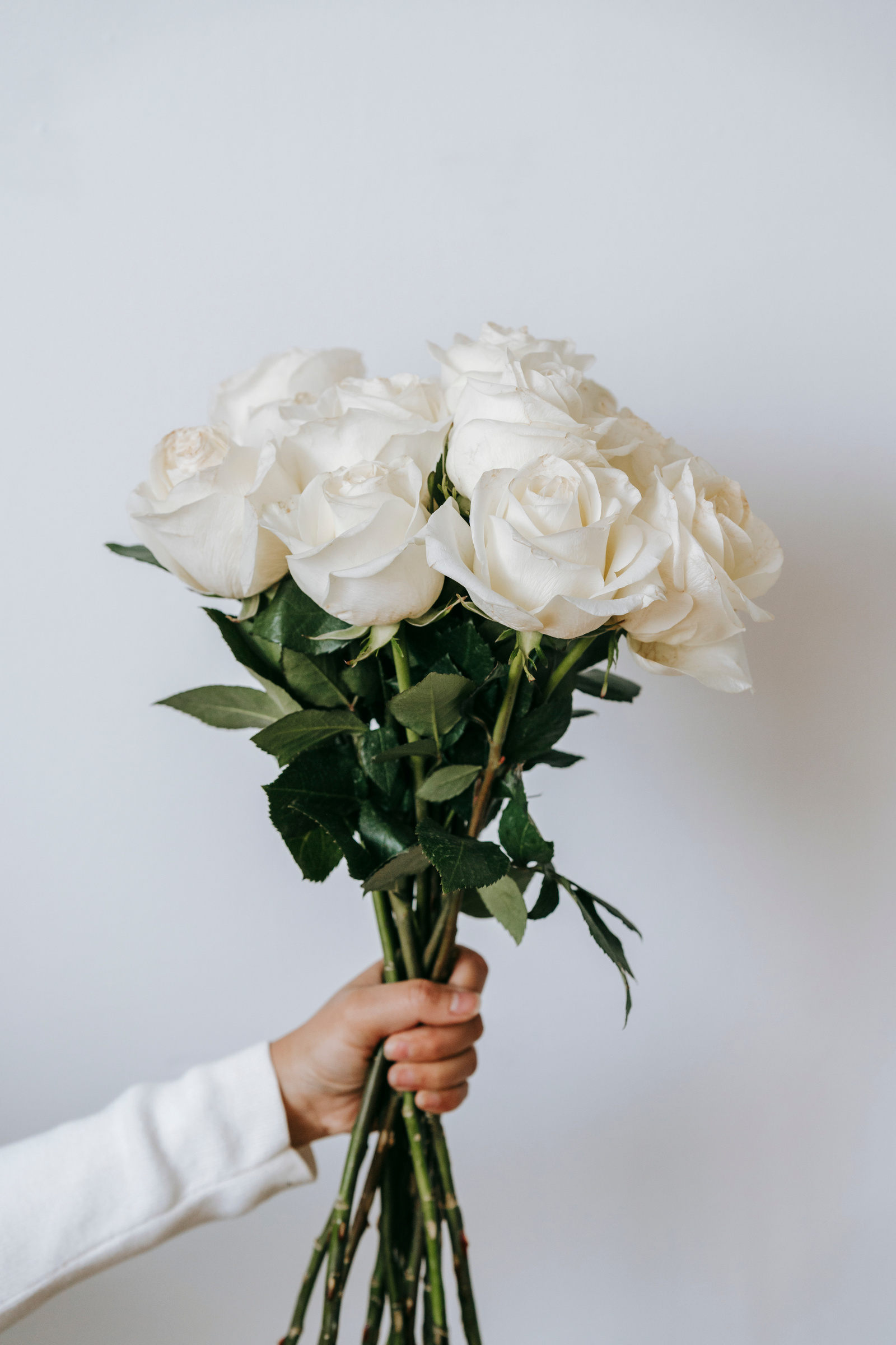 Anonymous person with bouquet of roses